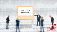Guerrilla Marketing: persone miniature che discutono sulla guerrilla marketing